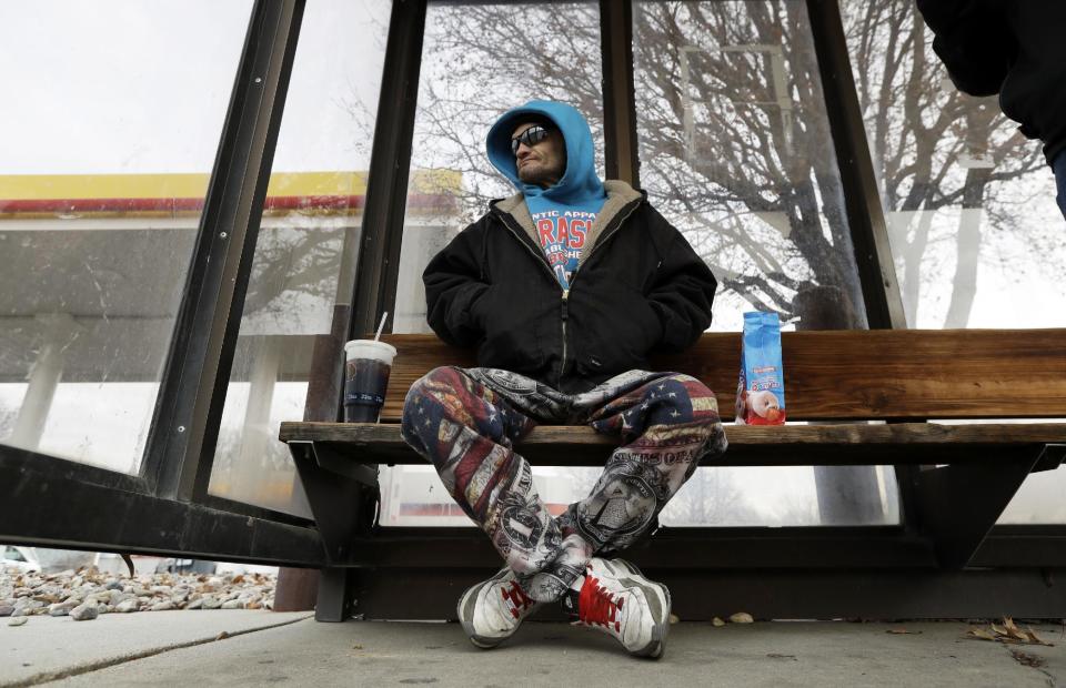 Rodney Rodwell waits to catch a bus in 11-degree weather in Lincoln, Neb., on Wednesday, Jan. 4, 2017. Rodwell, who works odd jobs while on disability and lost his car in 2016, says he wants Donald Trump to keep his campaign promise to stop illegal immigration, which he blames for keeping his pay down. He also hopes Trump legalizes medical marijuana nationally. (AP Photo/Charlie Neibergall)