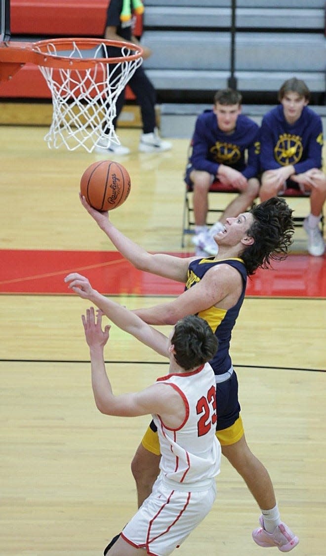 Brendan McComas of Airport goes to the basket against Milan’s Trey Chmeilewski during a 45-37 Airport win Tuesday night.