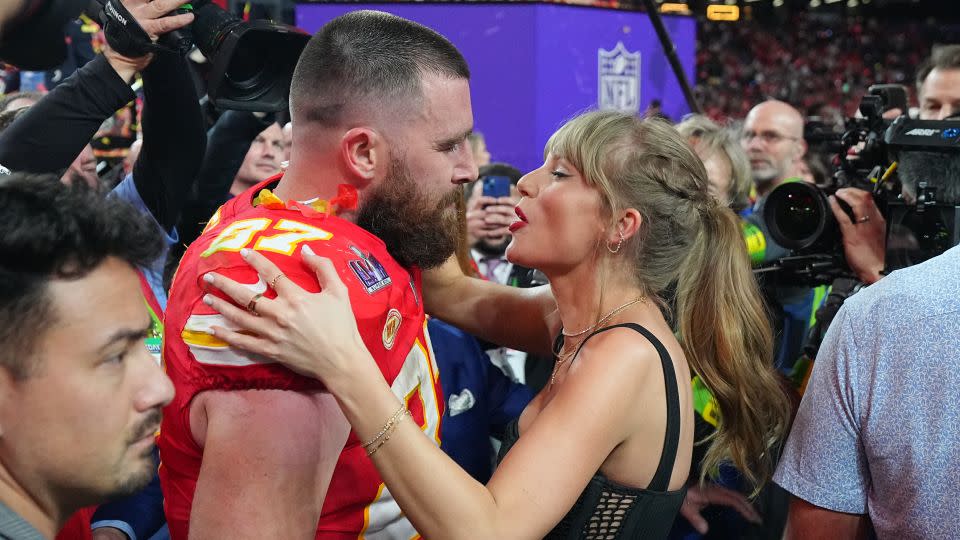 Taylor Swift embracing boyfriend Travis Kelce after a Chiefs playoff game in January. - Ezra Shaw/Getty Images