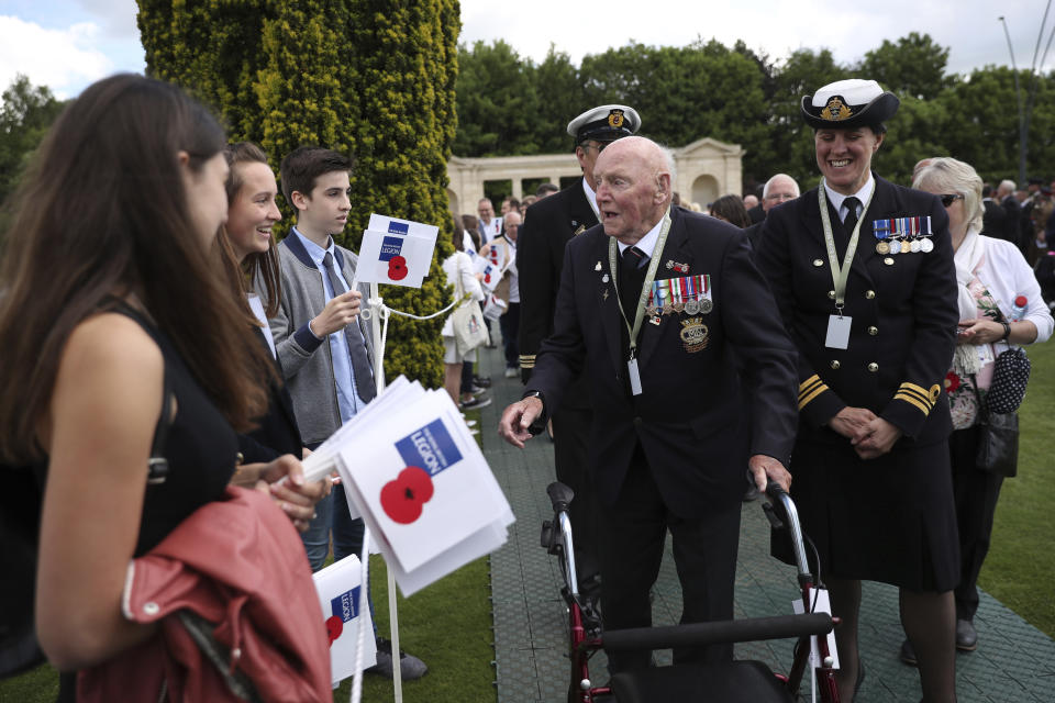 British veterans arrive at the Bayeux War Cemetery for a ceremony to mark the 75th anniversary of D-Day in Bayeux, Normandy, France, Thursday, June 6, 2019. (AP Photo/Francisco Seco)