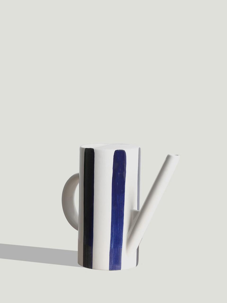 a blue and white striped watering can