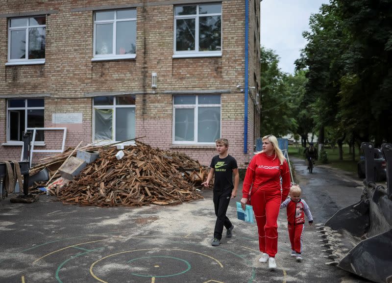 Svitlana and her son Illia visit his new school in Irpin