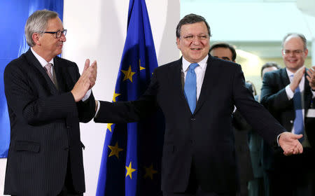 Outgoing president of the European Commission Jose Manuel Barroso reacts as he is applauded by incoming president of the EU Commission Jean-Claude Juncker (L) during a ceremony at the EU Commission headquarters in Brussels October 30, 2014. REUTERS/Francois Lenoir/File Photo