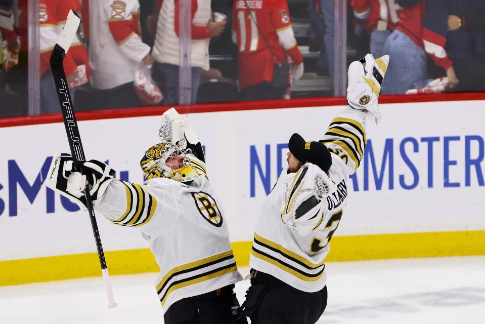 Boston Bruins goaltender Jeremy Swayman (1) and goaltender Linus Ullmark (35) celebrate after a playoff win against the Florida Panthers.