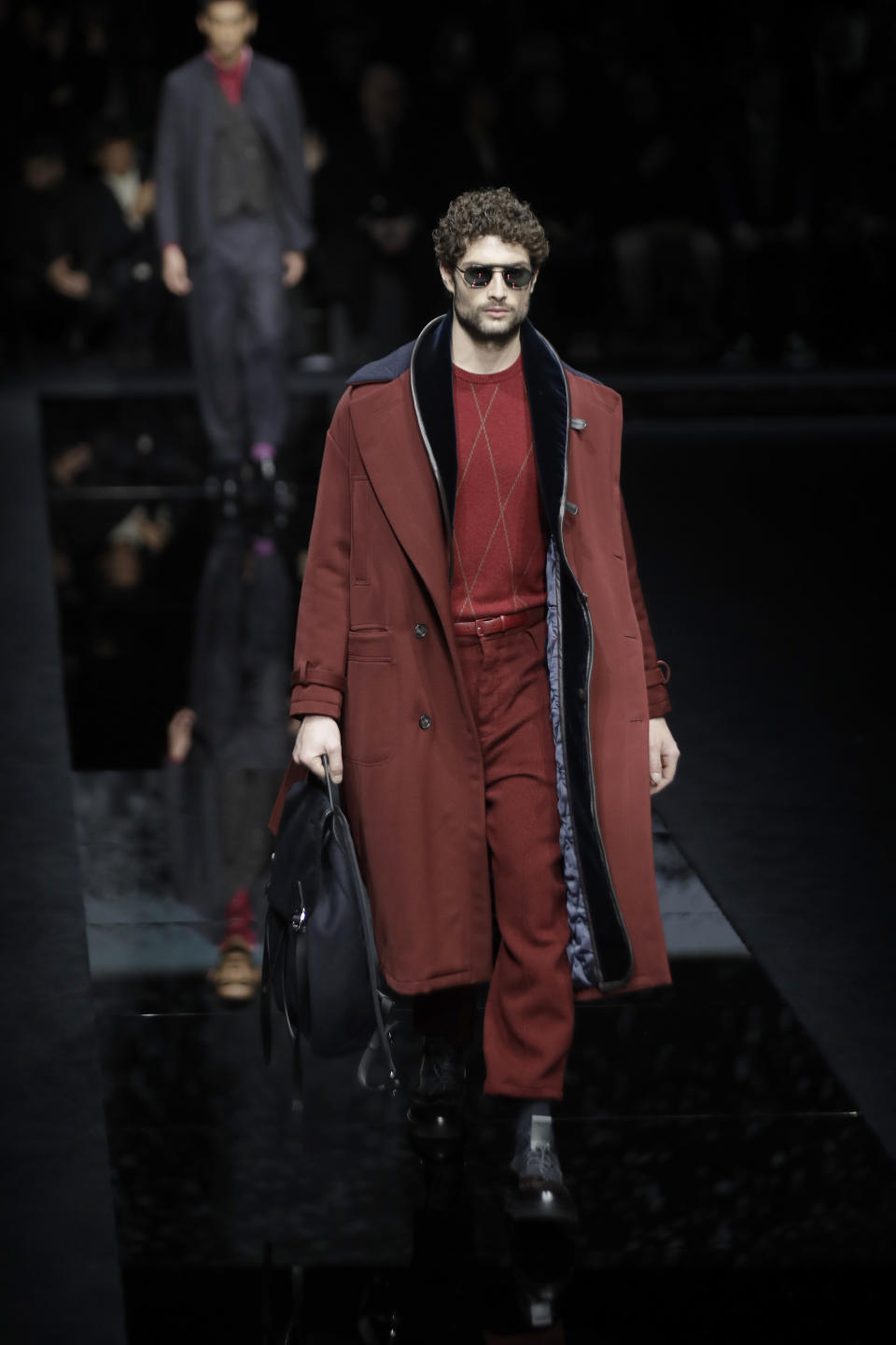 A model wears a creation as part of the Armani men's Fall-Winter 2020/21 collection, that was presented in Milan, Italy, Monday, Jan. 13, 2020. (AP Photo/Luca Bruno)