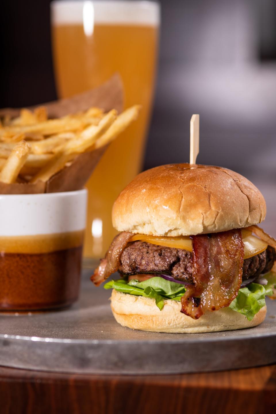 The farm to table burger at Maggie McFly's includes grass-fed beef from Lakeland, Fl, applewood smoked bacon, pickles from Pompano Beach, red onion, gouda, tomato, and bibb lettuce from Hardee on a potato bun.