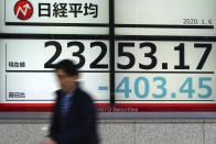 A man walks past at an electronic stock board showing Japan's Nikkei 225 index at a securities firm in Tokyo Monday, Jan. 6, 2020, in Tokyo, marking the start of this year's trading. Shares are skidding in Asia, with Tokyo's Nikkei 225 index down 2 percent on concern over escalating tensions in the Middle East following the killing by a U.S. air strike of an Iranian general. (AP Photo/Eugene Hoshiko)