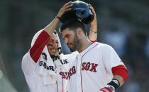 Boston Red Sox's Mookie Betts, left, greets J.D. Martinez at the dugout after Martinez's solo home run during the fourth inning of a baseball game against the New York Yankees in Boston, Saturday, Aug. 4, 2018. (AP Photo/Michael Dwyer)