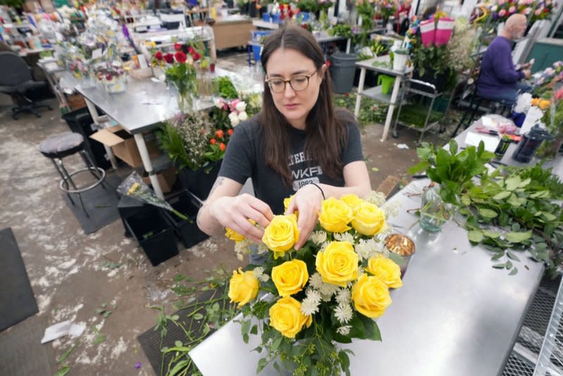 Floral arranger Brittney Schrautemeier prepares a yellow rose floral arrangement that will be sold for Valentines Day at Walter Knoll Florists in St. Louis last year. File Photo by Bill Greenblatt/UPI