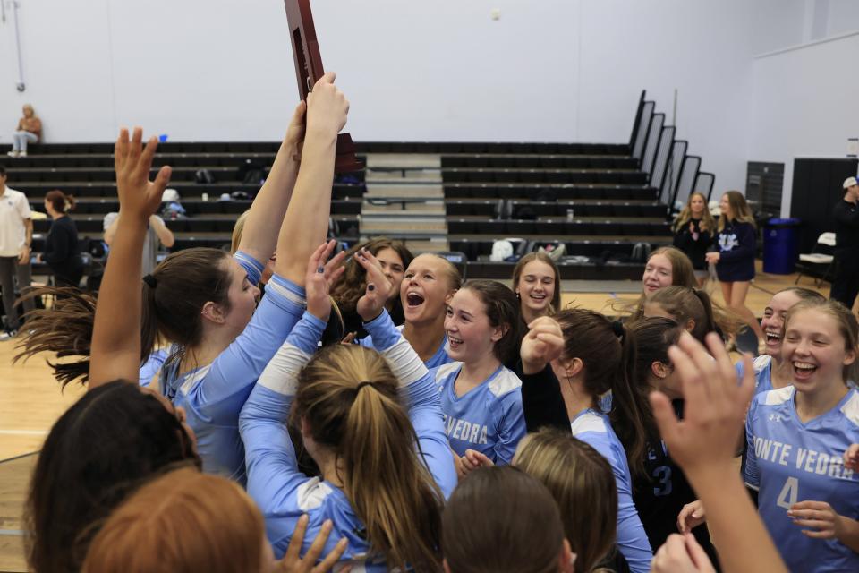 Ponte Vedra's Chelsea Sutton (14) holds up the trophy with teammates after a FHSAA District 3-6A girls volleyball championship against Fleming Island.