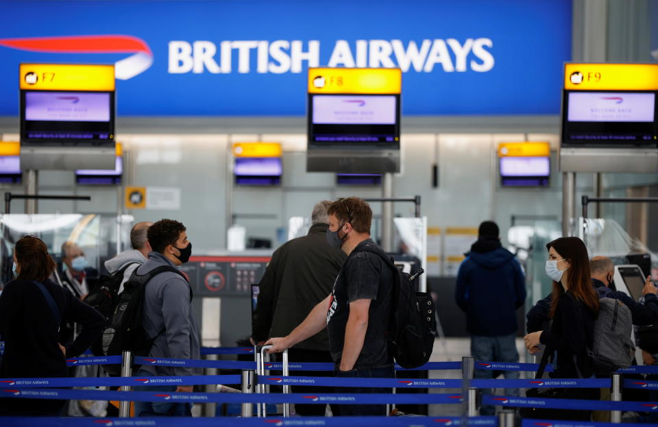 Passengers stand in a queue to the British Airways check-in desks in the departures. Photo: Reuters/John Sibley