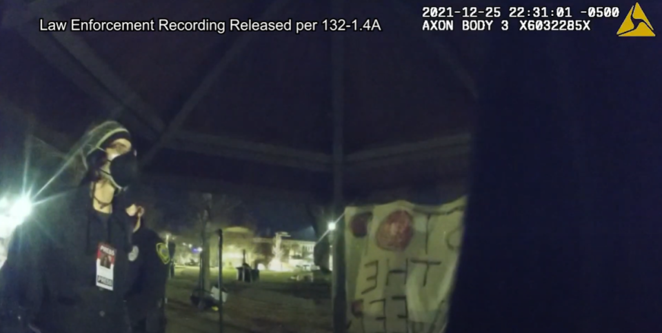 Matilda Bliss, a reporter with the Asheville Blade, being arrested at 10:31 p.m. on Dec. 25, 2021 in Aston Park.