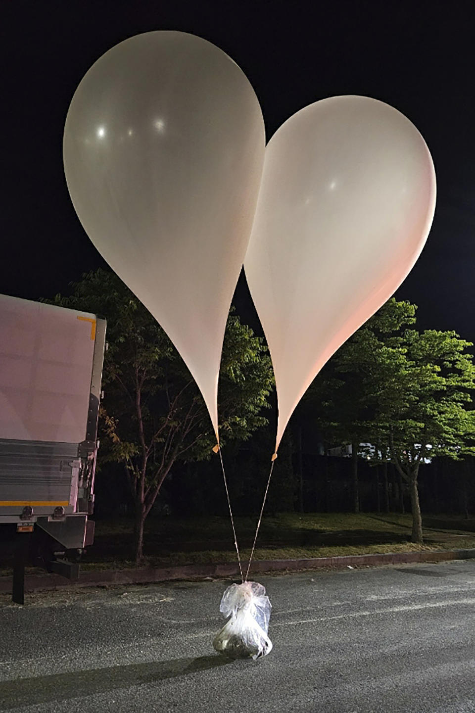 This photo provided by South Korea Defense Ministry, shows balloons with trash presumably sent by North Korea, in South Chungcheong Province, South Korea, Wednesday, May 29, 2024. In another sign of tensions between the war-divided rivals, South Korea's Joint Chiefs of Staff said North Korea also has been flying large numbers of balloons carrying trash toward the South since Tuesday night, in an apparent retaliation against South Korean activists for flying anti-Pyongyang propaganda leaflets across the border. (South Korea Presidential Office via AP)