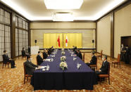 China' Foreign Minister Wang Yi, third left, meets with his Japanese counterpart Toshimitsu Motegi, third right, amid the coronavirus outbreak, in Tokyo on Tuesday, Nov. 24, 2020. Wang met Motegi on Tuesday to discuss ways to revive their pandemic-hit economies as well as regional concerns over China’s growing influence. (Issei Kato/Pool Photo via AP)