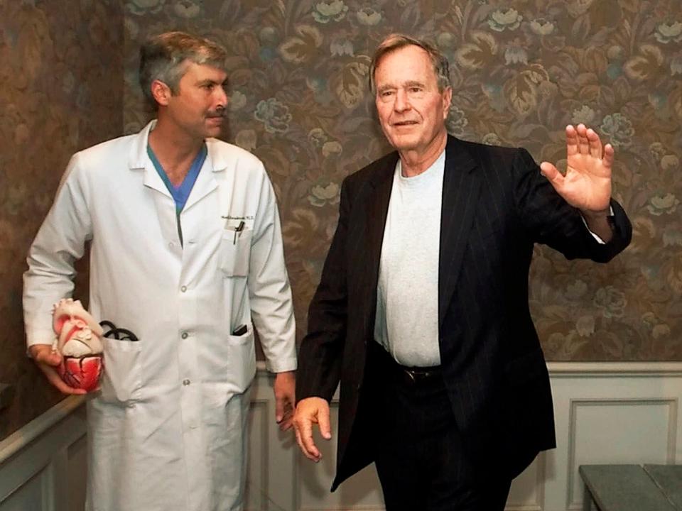 Mark Hausknecht (left), who once treated former president George W Bush, was fatally shot by a fellow bicyclist on Friday 20 July: AP