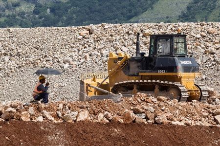 A worker hides from the sun on the Bar-Boljare highway construction site in Klopot, Montenegro June 11, 2018. Picture taken June 11, 2018. REUTERS/Stevo Vasiljevic