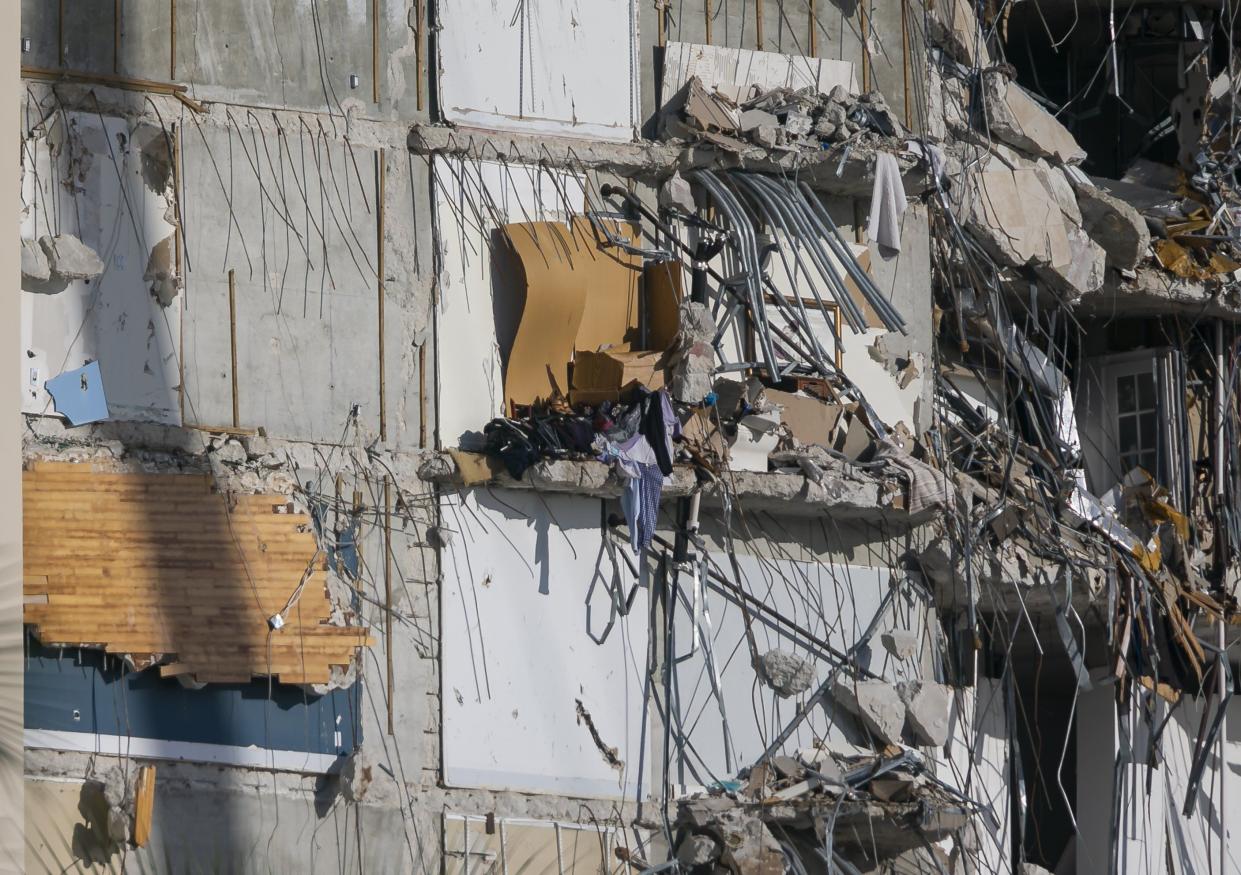 Personal belongings dangle from inside the partially collapsed Champlain Towers South Condo building in Surfside, Fla. on Saturday, July 3, 2021.