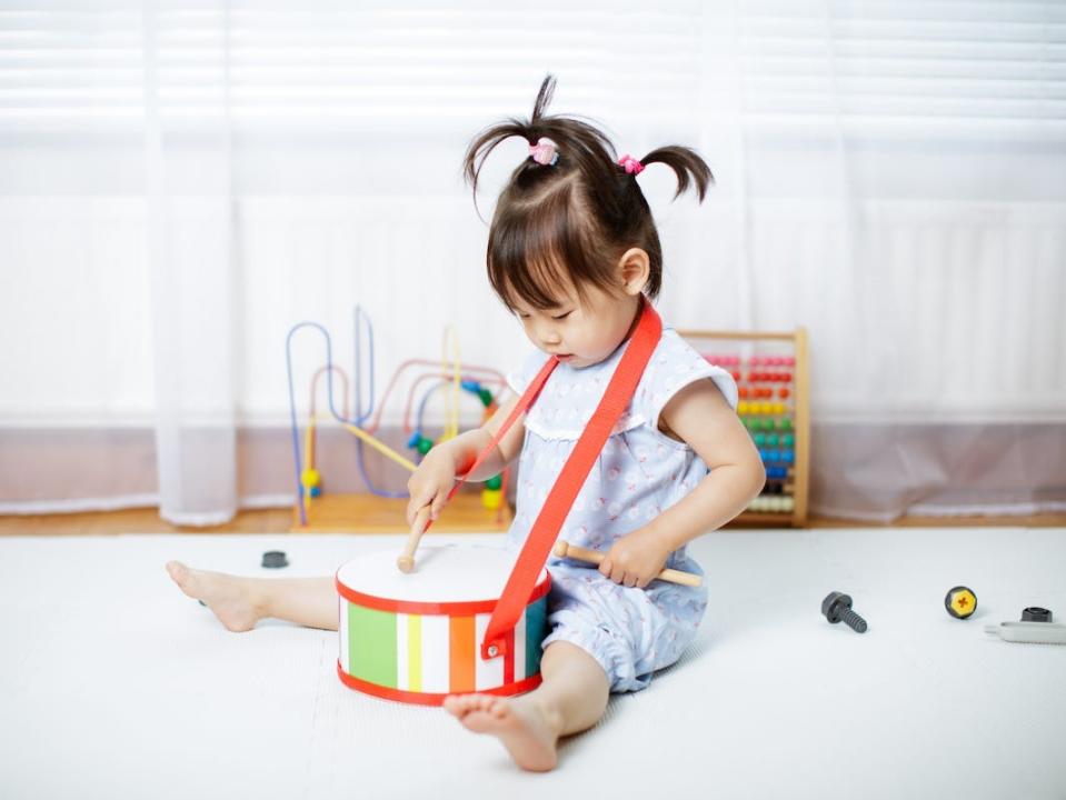 little girl plays drum