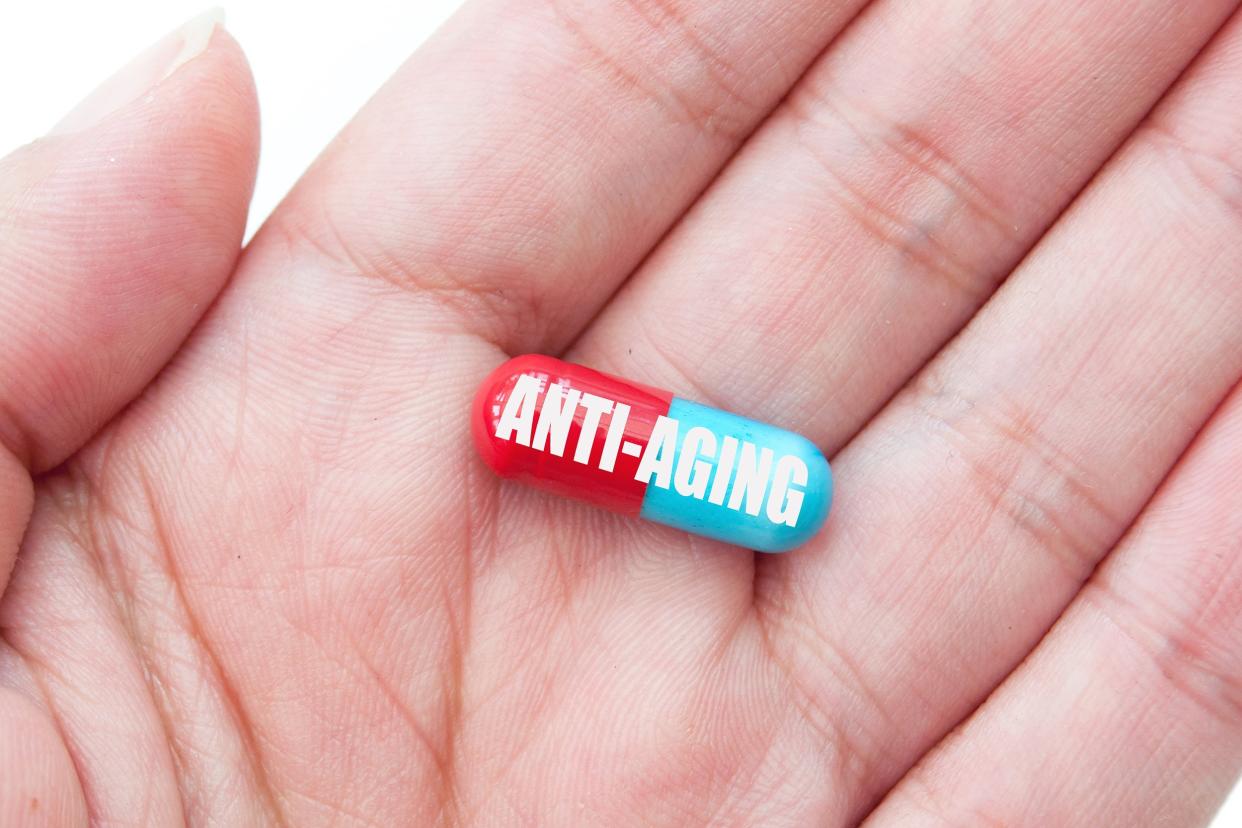 anti-aging pill in palm of hand