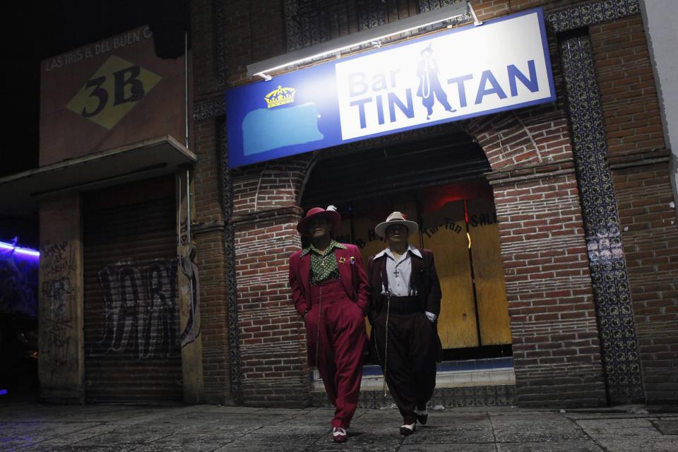 Jesus Gonzalez de la Rosa and Arellano Diaz wear their "Pachuco" outfits while posing for a photograph outside a dance hall named after late Mexican Pachuco Tin Tan, in Mexico City