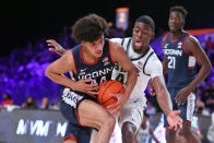 In this photo provided by Bahamas Visual Services, Connecticut guard Andre Jackson (44) drives as Michigan State forward Gabe Brown (44) defends during an NCAA college basketball game at Paradise Island, Bahamas, Thursday, Nov. 25, 2021. (Tim Aylen/Bahamas Visual Services via AP)