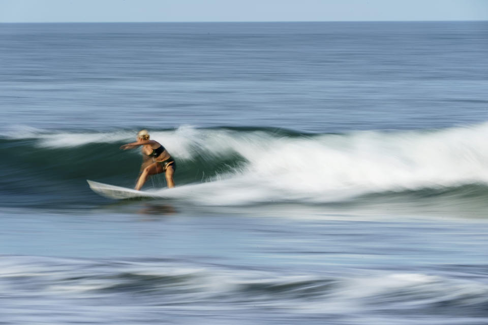 Surfer Anat Lelior, of Israel, rides a wave during a practice session at Tsurigasaki beach at the Tokyo 2020 Olympics in Ichinomiya, Japan, Wednesday, July 21, 2021. (AP Photo/David Goldman)