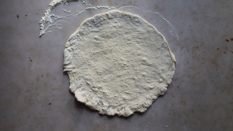 Hand stretched raw pizza dough
