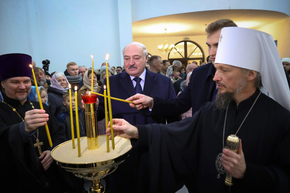 FILE - Belarusian President Alexander Lukashenko, center, his son, Nikolai, second right, and Metropolitan Veniamin of Minsk and Zaslavl, attend Christmas services in the Church of the Holy Prophet John the Baptist outside Minsk, Belarus, on Sunday, Jan. 7, 2024. Lukashenko has signed into law a measure requiring all religious organizations in the country of 9.5 million to re-register with authorities or face being outlawed. (Belarusian Presidential Press Service via AP, File)