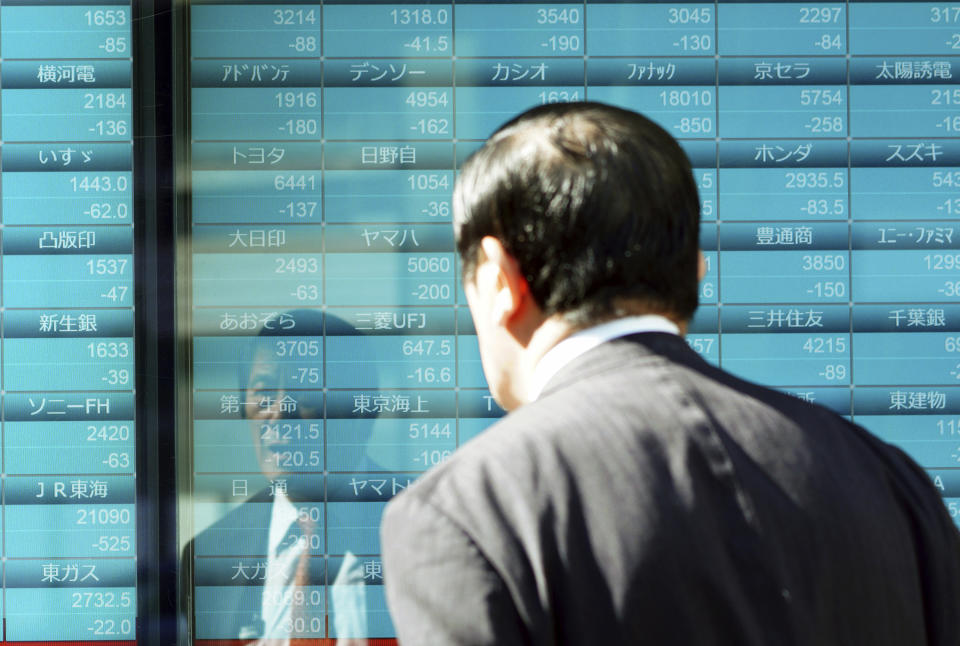 A man looks at an electronic stock board showing Japan's Nikkei 225 index and other countries index at a securities firm Thursday, Oct. 25, 2018 in Tokyo. Shares fell moderately in Asia on Thursday after another torrent of selling gripped Wall Street overnight, sending the Dow Jones Industrial Average plummeting more than 600 points and erasing its gains for the year. Japan’s Nikkei 225 index sank sharply on the open but leveled off, regaining some lost ground. (AP Photo/Eugene Hoshiko)