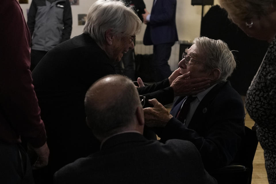 D-Day veteran Bill Gladden greets friends at a surprise 100th birthday party in Haverhill, England, Friday, Jan. 12, 2024. Gladden spoke to the AP on the eve of his 100th birthday, and is a veteran of the 6th Airborne Armoured Reconnaissance Regiment, part of the British 6th Airborne Division, he landed by glider on the afternoon of D-day, 6th June 1944 in Normandy. Gladden was born January. 13, 1924. (AP Photo/Alastair Grant)