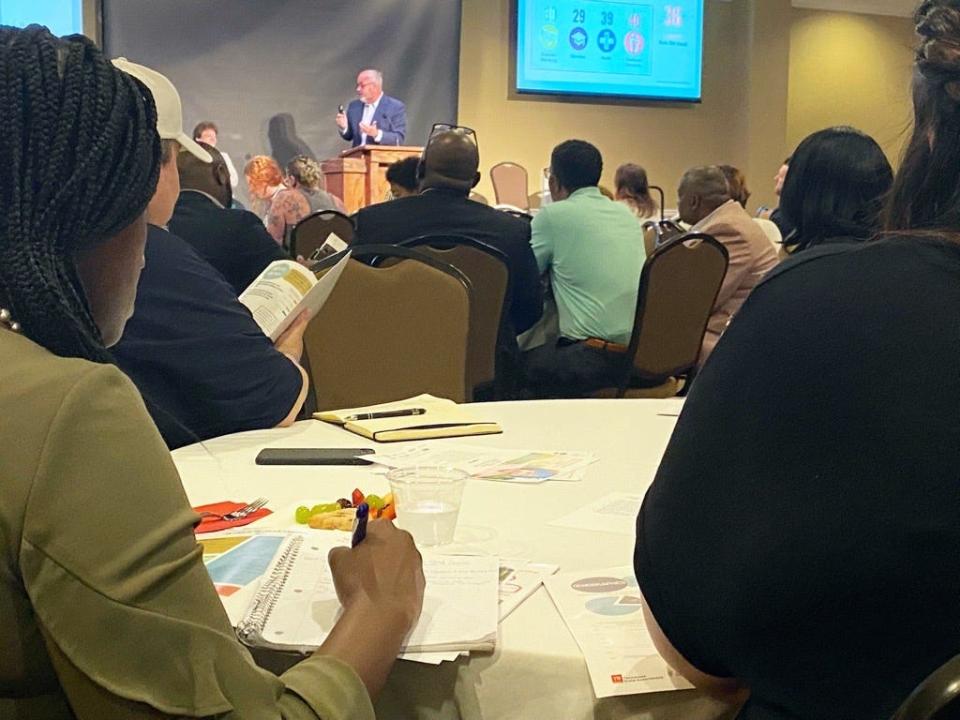 Attendees take notes at the State of the Child summit Friday.