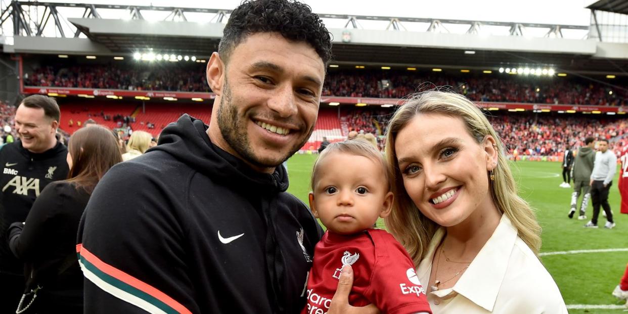 alex oxlade chamberlain of liverpool posing for a photograph with perrie edwards and their baby boy at the end of the premier league match