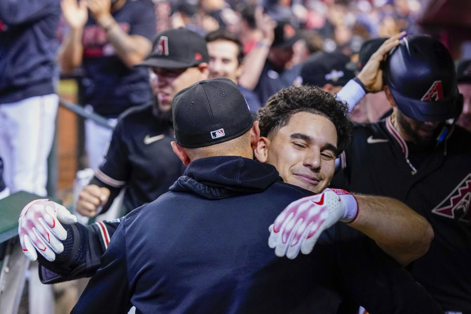 Arizona Diamondbacks' Alek Thomas celebrates in the dugout after a two-run home run against the Philadelphia Phillies during the eighth inning in Game 4 of the baseball NL Championship Series in Phoenix, Friday, Oct. 20, 2023. (AP Photo/Ross D. Franklin)