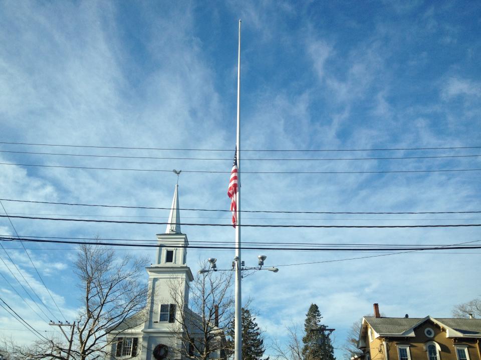 A flag is seen at half-staff on Main Street in Newtown, Conn.