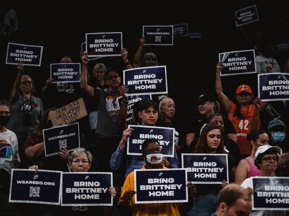 Fans hold signs to support Brittney Griner.