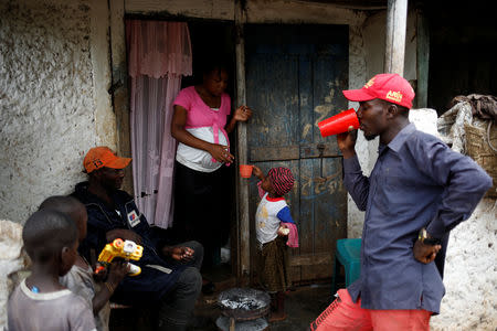 Brothers Manes (L) and Fresnels Exalus (R), and Naida Ogisten have a snack with relatives in the house of Manes and Naida in Boucan Ferdinand, Haiti, October 8, 2018. "These people (politicians) win... and they forget about us," Fresnels said. "When there is drought, we have to go to fetch water from the Dominican (Republic). They don't even send a little bag here," Manes said. REUTERS/Andres Martinez Casares