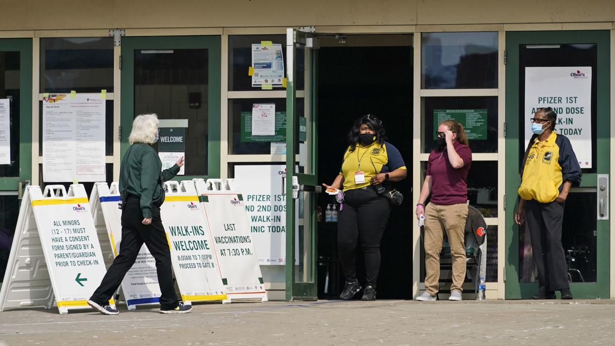 A woman walks into Ohio's COVID-19 mass vaccination clinic at Cleveland State University, Tuesday, May 25, 2021, in Cleveland. Nearly 2.8 million residents have registered for Ohio's Vax-a-Million vaccination incentive program, with participants hoping to win either the $1 million prize for adults or a full-ride college scholarship for children, Gov. Mike DeWine announced Monday, May 24. The winners will be announced Wednesday night at the end of the Ohio Lottery's Cash Explosion TV show, and then each Wednesday for the next four weeks.