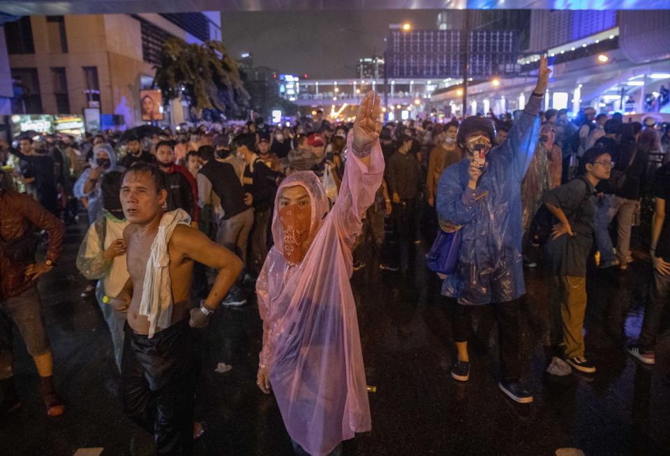 Pro democracy demonstrators regroup after police cleared their protest venue in Bangkok, Thailand, Friday, Oct. 16, 2020. Thailand prime minister has rejected calls for his resignation as his government steps up efforts to stop student-led protesters from rallying in the capital for a second day in defiance of a strict state of emergency. (AP Photo/Gemunu Amarasinghe)