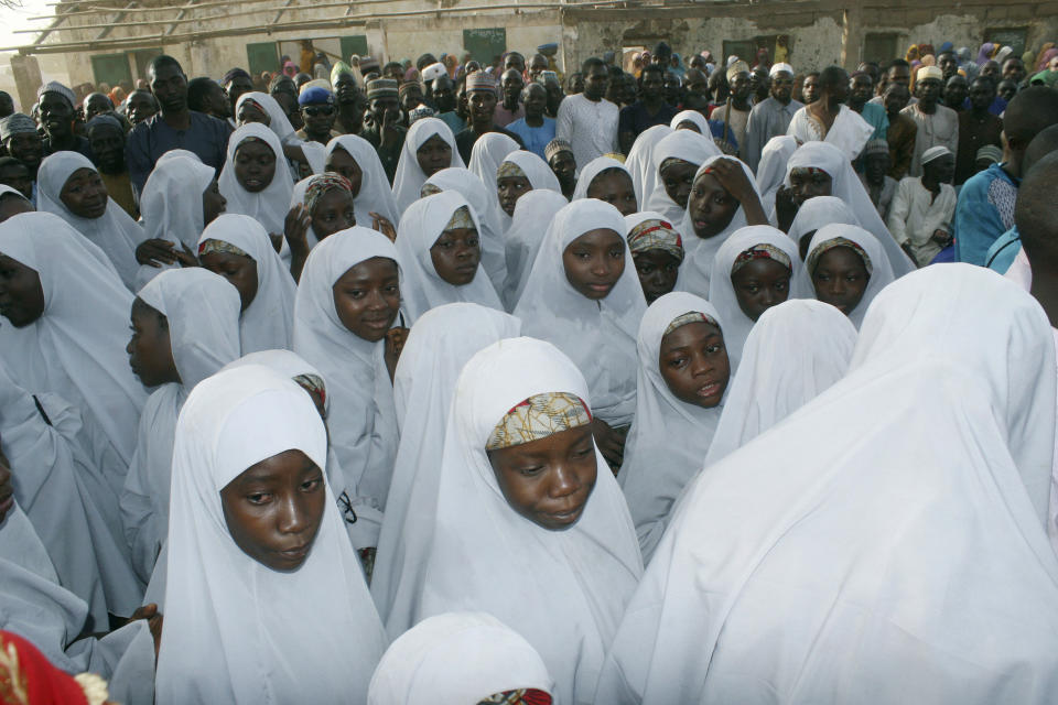 FILE - Then-recently freed students of the LEA Primary and Secondary School Kuriga gather upon arrival to reunite with their parents after more than two weeks in captivity, in Kuriga, Nigeria, Thursday, March 28, 2024. Their experience represents a worrying new development in Nigeria, Africa's most populous country where the mass abduction of Chibok schoolgirls a decade ago marked a new era of fear even as nearly 100 of the girls remain in captivity. An array of armed groups now focus on abducting schoolchildren, seeing in them a lucrative way to fund other crimes and control villages in the nation's mineral-rich but poorly-policed northwestern region. (AP Photo/Olalekan Richard, File)