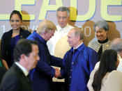President Trump and Russian President Vladimir Putin shake hands as they take part in a family photo at the APEC summit. Sputnik/Mikhail Klimentyev/Kremlin via REUTERS
