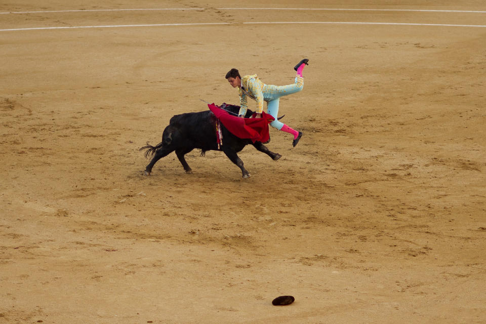 Spanish bullfighter David Galan is tossed by a Jose Escolar's ranch fighting bull during a bullfight of the San Isidro fair at Las Ventas bullring in Madrid, Monday, May 13, 2013. For a month bullfights take place every afternoon in what has been recognized as one of the most important bullfighting fairs in the world. Bullfighting is an ancient tradition in Spain and the season runs from March to October. (AP Photo/Daniel Ochoa de Olza)