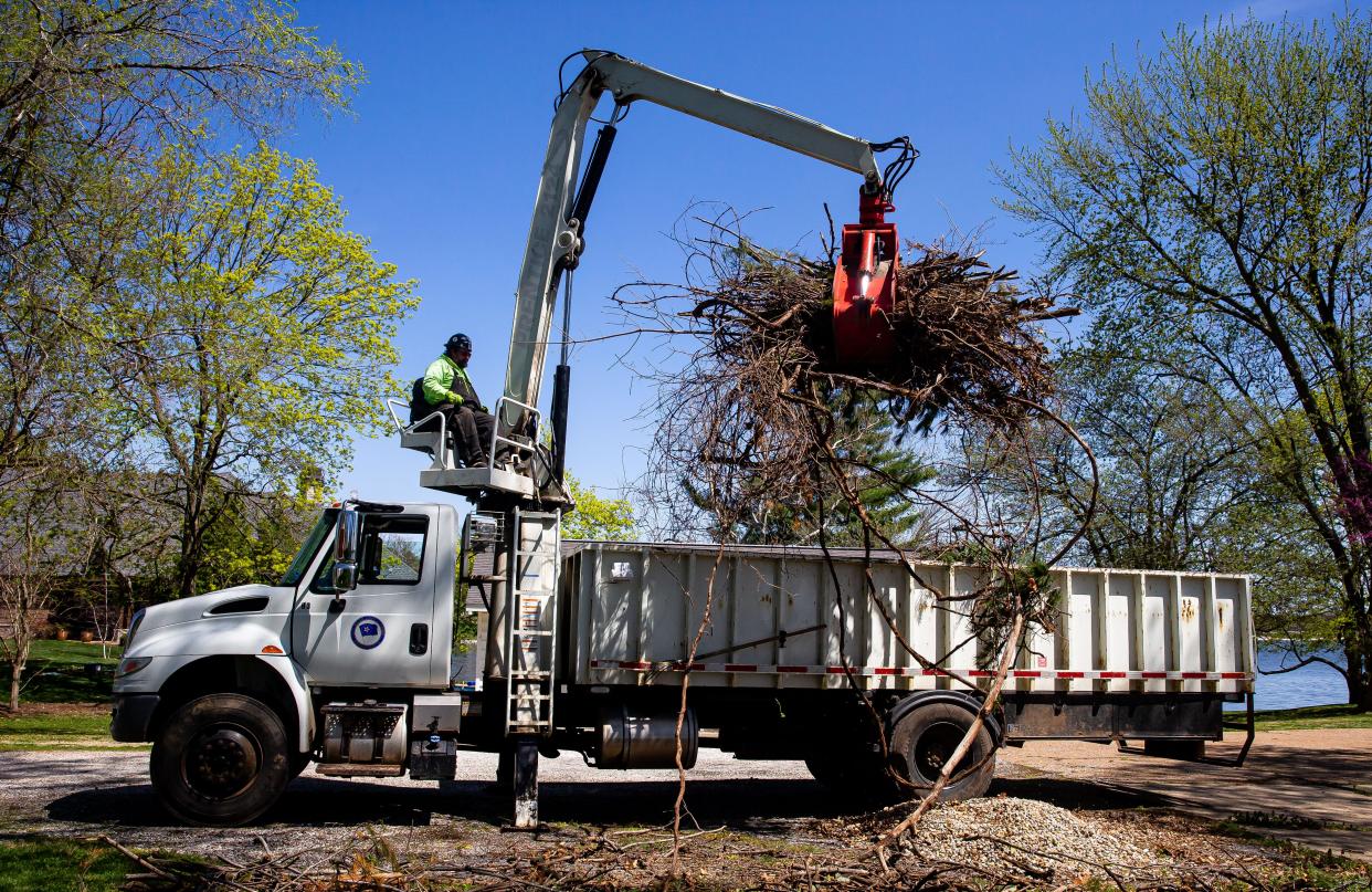 Tom Murphy with City, Water, Light and Power uses a grapple truck to load debris for branch pickup around the lake area along Linden Lane in Springfield, Ill., Tuesday, April 13, 2021. The city of Springfield begins its curbside branch pickup Aug. 1.