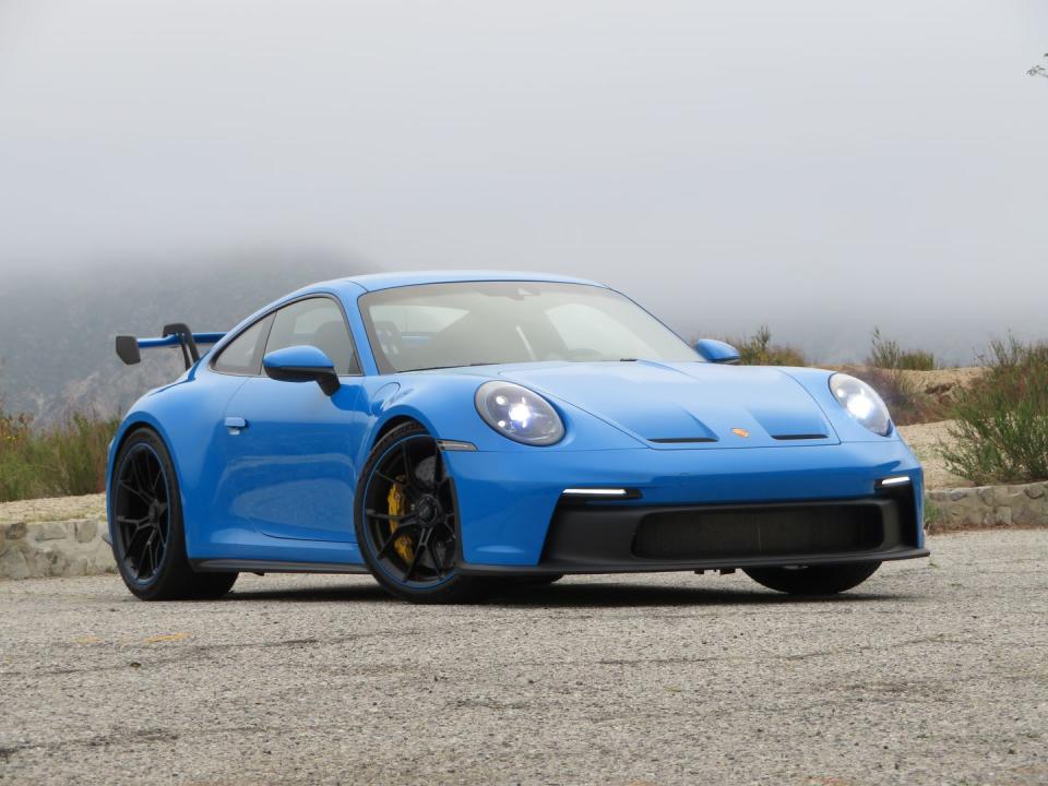 <p>"Here’s the headline: the 992 GT3 is bigger in every dimension than the old car, makes no more power than the old car, and has either the seven-speed PDK or the six-speed manual from the old car. And yet, it’s substantially faster, to the tune of 17 seconds a lap around the Nordschleife. Somebody, as the kids say, has been Doing Science." - <em><a href="https://www.roadandtrack.com/new-cars/first-drives/a36178330/2022-porsche-911-gt3-first-drive/" rel="nofollow noopener" target="_blank" data-ylk="slk:R&T April 2021;elm:context_link;itc:0;sec:content-canvas" class="link ">R&T April 2021</a></em></p><ul><li><strong>Price: </strong>$162,450 (base)</li><li><strong>Engine: </strong>4.0-liter flat-six</li><li><strong>Output: </strong>502 hp/346 lb-ft</li><li><strong>Transmission: </strong>6-speed manual</li><li><strong>Curb Weight: </strong>3126 lb </li></ul>