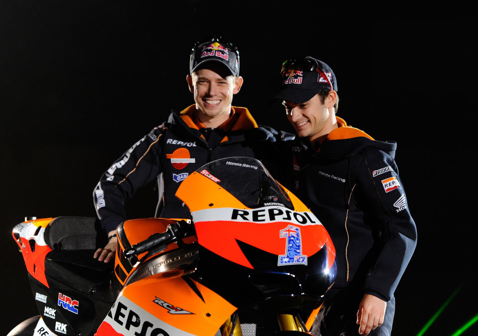 Australian  MotoGP rider Casey Stoner (L) and Spanish MotoGP rider Dani Pedrosa wave to fans on March 3, 2012 during the presentation of the Repsol Honda Team 2012 at the Sports Palace in Madrid.
                 AFP PHOTO/Dani POZO (Photo credit should read DANI POZO/AFP/Getty Images)