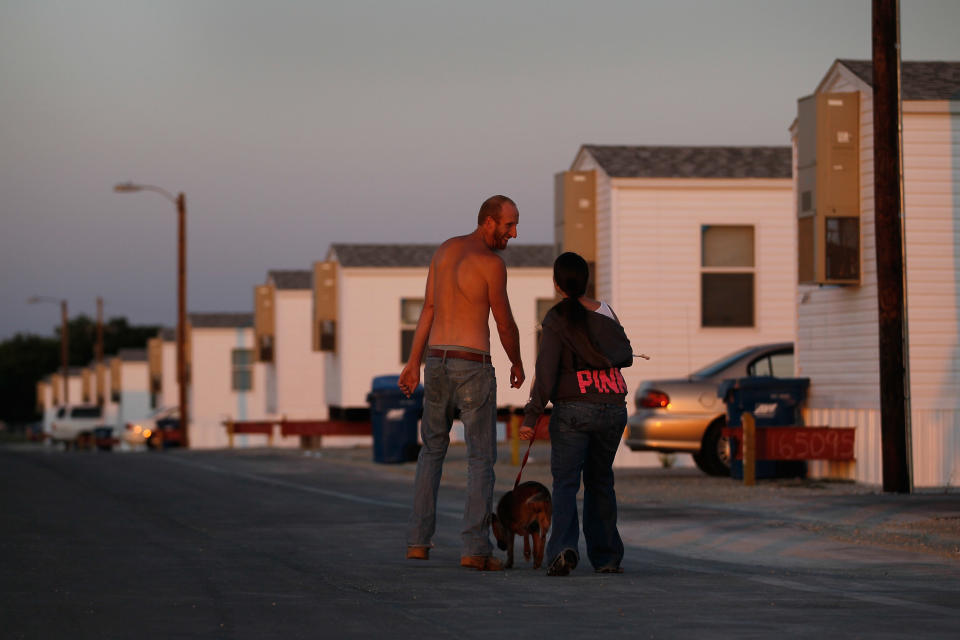 JOPLIN, MO - MAY 22:  Levi Welde (L) walks with his friend Krystal Barnes in the FEMA trailer park that she lives in after her home was destroyed when a tornado hit the city one year ago on May 22, 2012 in Joplin, Missouri. Today marked the one-year anniversary of the EF-5 tornado that devastated the town leaving behind a path of destruction along with 161 deaths and hundreds of injuries, but one year later people continue to move out of the temporary FEMA housing sites and into permanent homes.  (Photo by Joe Raedle/Getty Images)