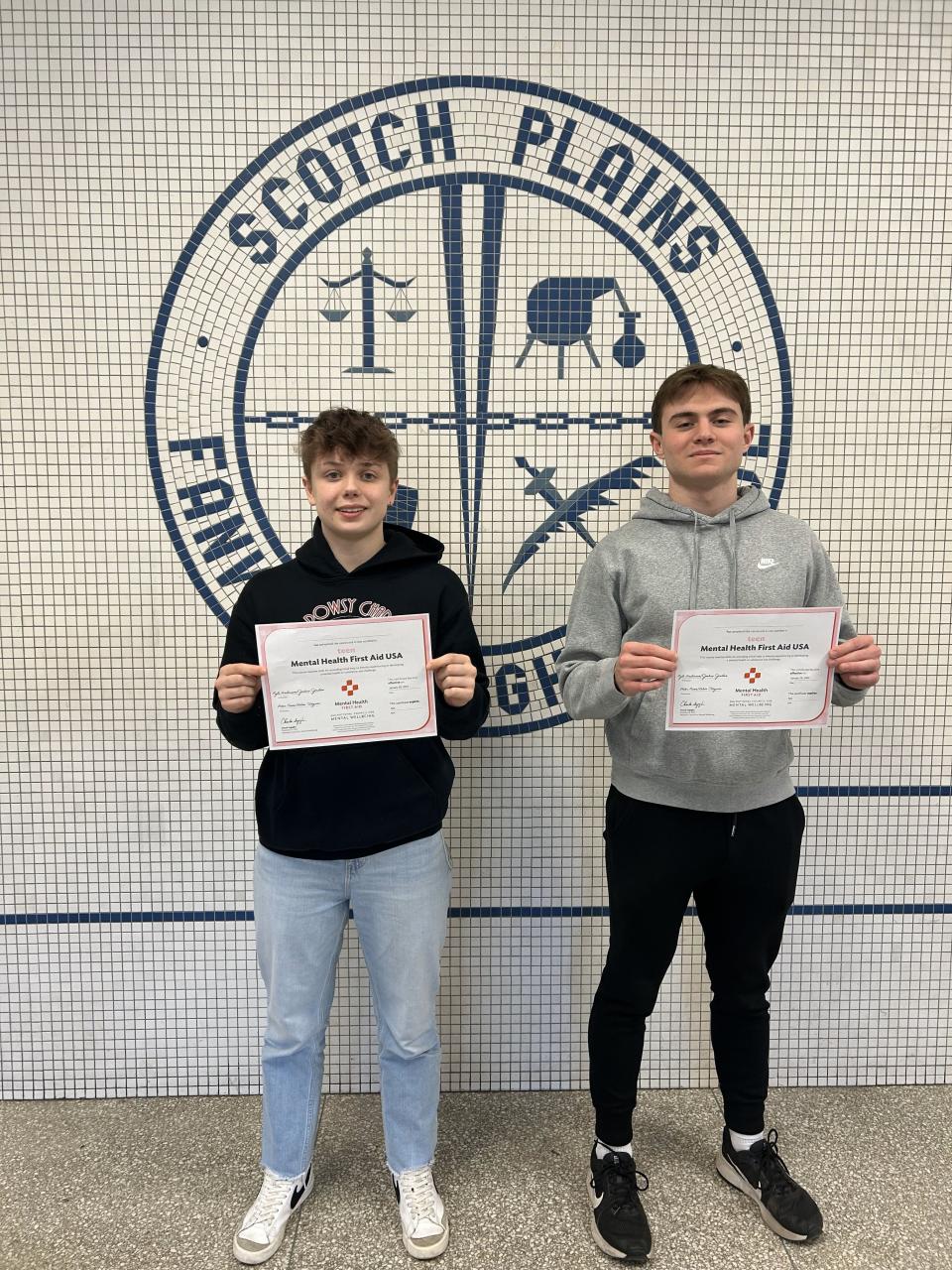 Ant Butters, left, and Cooper Tamase hold up their teen Mental Health First Aid (tMHFA) certificates. The Scotch Plains-Fanwood High School students were among the more than 300 Raiders who participated in the national program designed to provide students with the necessary tools to recognize, comprehend and respond to indicators of mental health and substance use issues among their peers.