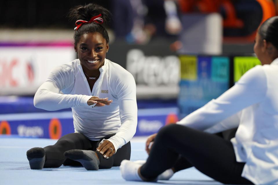 Simone Biles laughs while talking to Jordan Chiles during podium training beforethe Core Hydration Classic at NOW Arena.