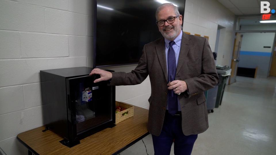 South Burlington High School principal Patrick Burke poses with the school's new "sharing fridge" on Jan. 24, 2023.