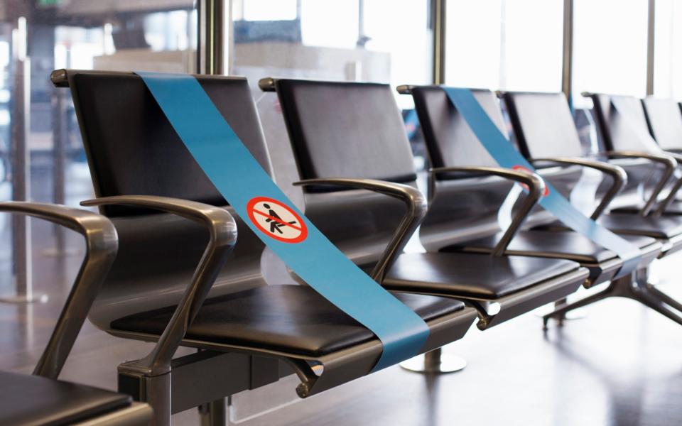 Signs marking that only every other seat can be used in airport - Kathrin Ziegler/Getty