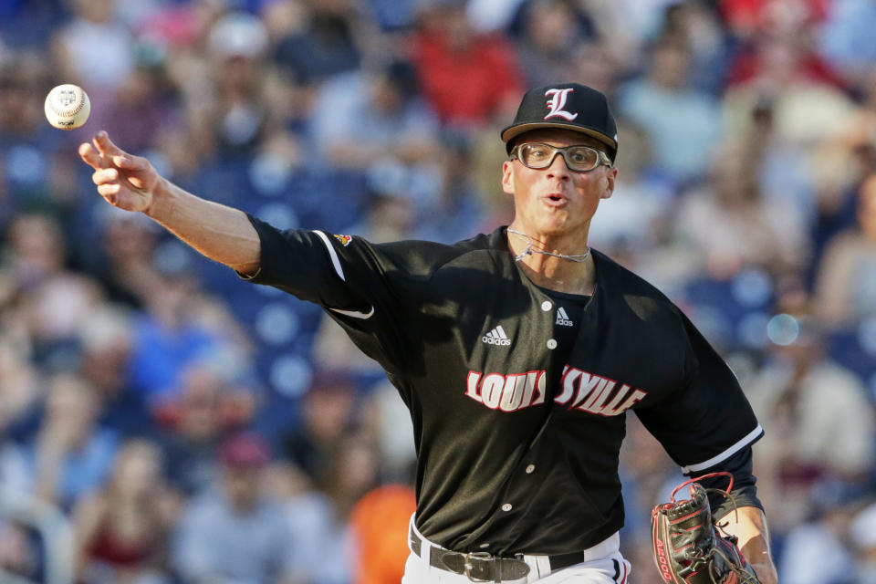 Louisville pitcher Luke Smith throws to first base during the third inning of the team's NCAA College World Series baseball game against Vanderbilt in Omaha, Neb., Friday, June 21, 2019. (AP Photo/Nati Harnik)